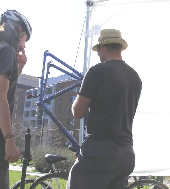 Joe working with a cyclist at the mobile repair truck